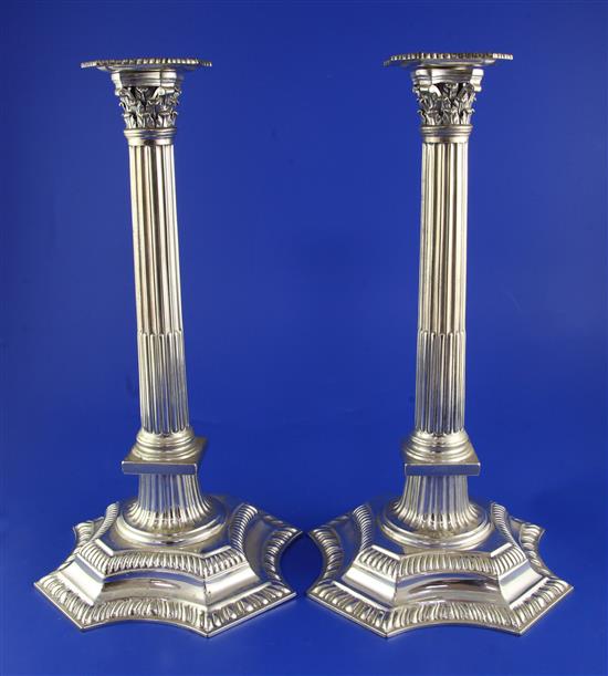 A pair of George V silver corinthian column candlesticks, 37 oz.